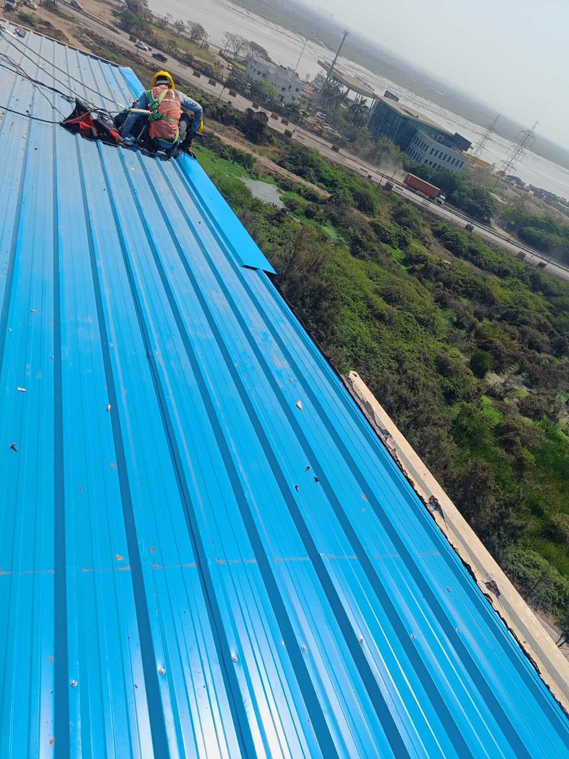Commercial architectural roofing at Oberoi Mall, Mumbai: Specialized Kliplok roof-on-roof installation by Rishonn & Reyansh for leak-proof retail infrastructure.